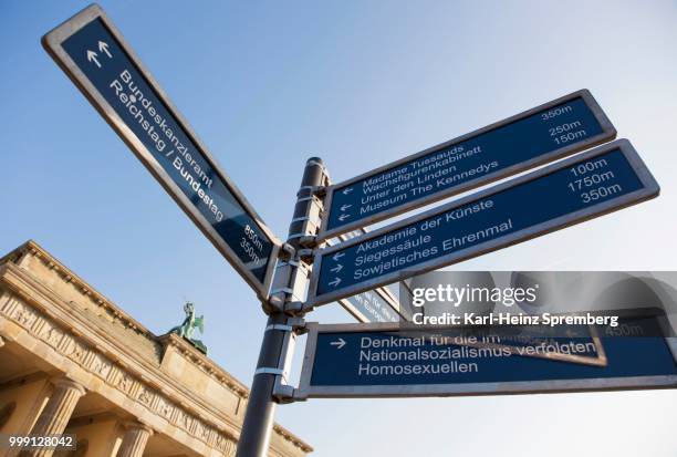 signpost at the brandenburg gate, city centre, berlin, germany - city gate stock pictures, royalty-free photos & images