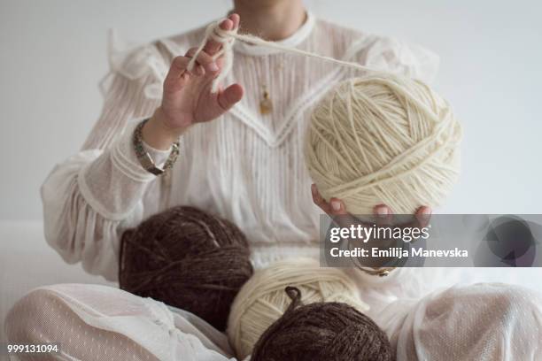 close up of a woman holding natural wool yarns - boucle stock pictures, royalty-free photos & images