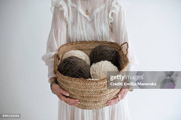 close up of a woman holding natural wool yarns - emilija manevska stock-fotos und bilder