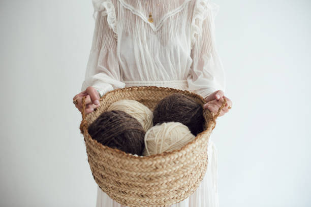 close up of a woman holding natural wool yarns - 天然繊維 ストックフォトと画像