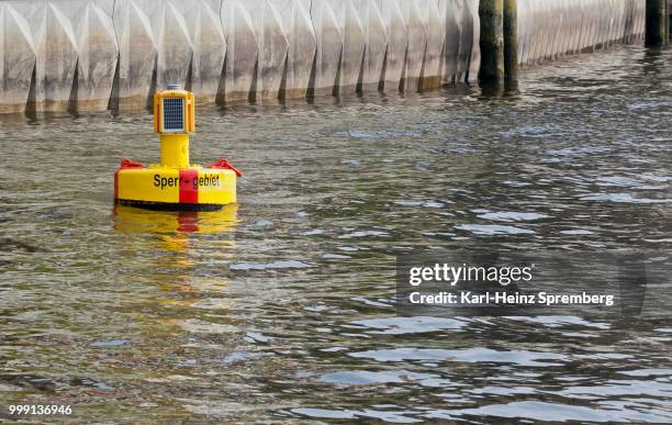 yellow buoy in the harbour basin of hamburg, hamburg, germany - closed captions stockfoto's en -beelden