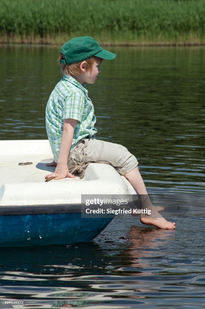 Boy when pedal boat, Lake Gartower See, Wendland, Lower Saxony, Germany