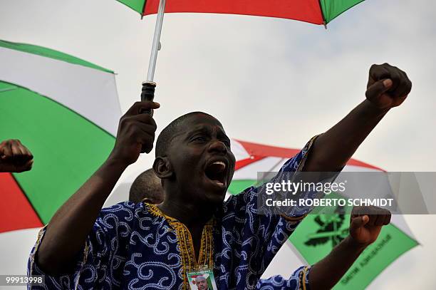 Burundi's Nkurunziza on God and grassroots development** A supporter of Burundian President Pierre Nkurunziza screams during a political rally in the...