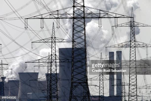 generation of electricity, a coal power station and power poles, north rhine-westphalia, germany - biological process foto e immagini stock