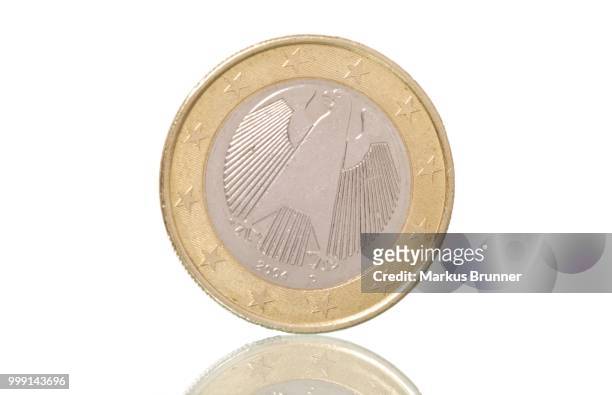 german euro coin, on slope, symbolic image for euro crisis - eurozone debt crisis stock pictures, royalty-free photos & images