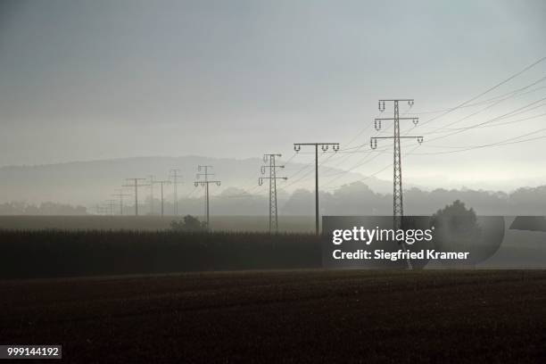 electricity pylons with morning mist, upper swabia, baden-wuerttemberg, germany - technic stock pictures, royalty-free photos & images