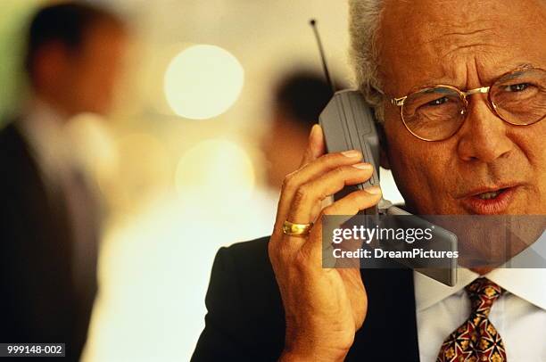 mature businessman using mobile phone, close-up - 90s cell phone bildbanksfoton och bilder