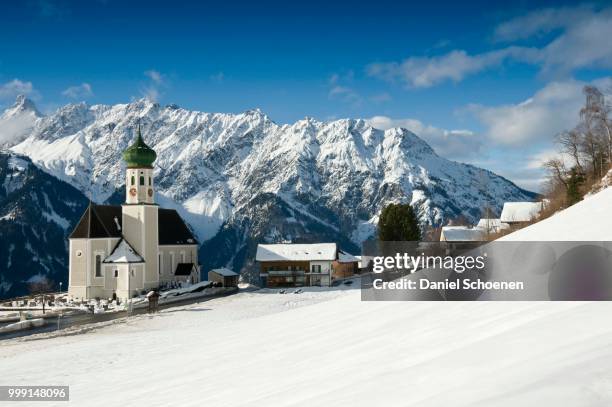 parish and pilgrimage church of st. bartholomew, baroque church, in front of mountain range, bartholomaeberg, montafon, vorarlberg, austria - bartholomew stock pictures, royalty-free photos & images