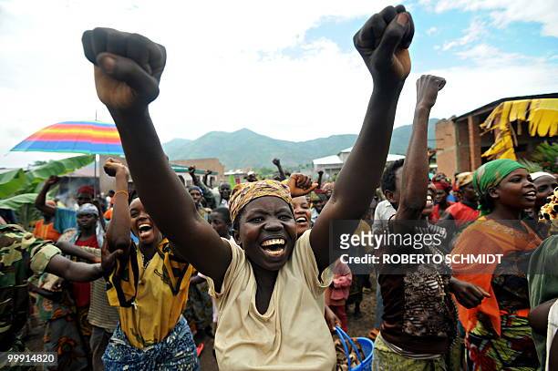Burundi's Nkurunziza on God and grassroots development** A supporter of Burundian President Pierre Nkurunziza raises her fists as she reacts seeing...