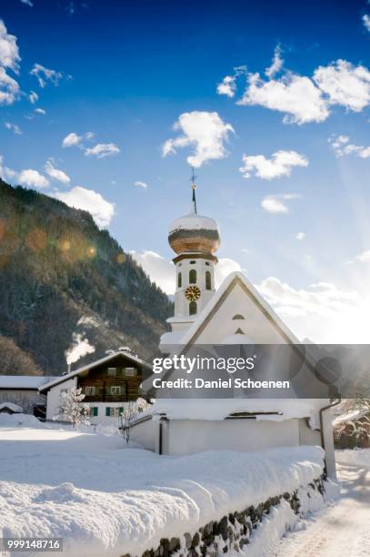 snow-covered church and sun rays, st gallenkirch, montafon, vorarlberg, austria - onion dome stock pictures, royalty-free photos & images