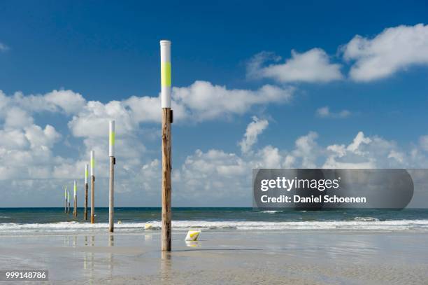 beach and marker posts against the sky, st peter-ording, schleswig-holstein, germany - holstein friesian stockfoto's en -beelden