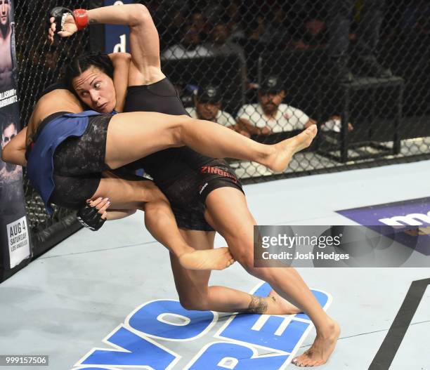 Cat Zingano takes down Marion Reneau in their women's bantamweight fight during the UFC Fight Night event inside CenturyLink Arena on July 14, 2018...