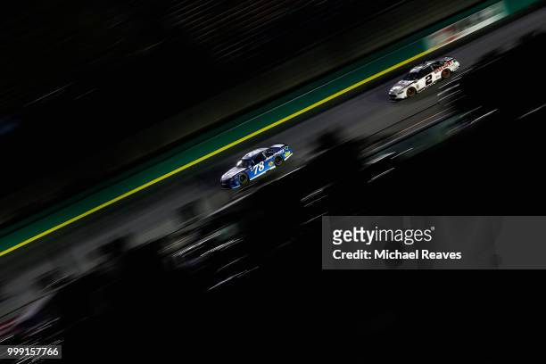 Martin Truex Jr., driver of the Auto-Owners Insurance Toyota, leads Brad Keselowski, driver of the Discount Tire Ford, during the Monster Energy...