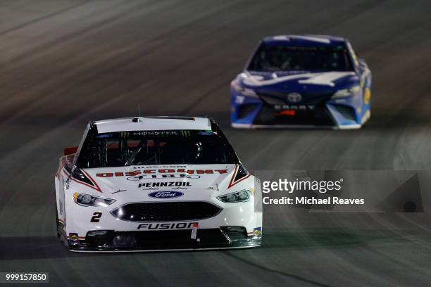 Brad Keselowski, driver of the Discount Tire Ford, leads Martin Truex Jr., driver of the Auto-Owners Insurance Toyota, during the Monster Energy...