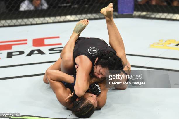 Cat Zingano elbows Marion Reneau in their women's bantamweight fight during the UFC Fight Night event inside CenturyLink Arena on July 14, 2018 in...