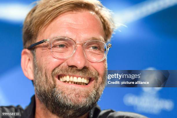 Dpatop - Liverpool's coach Juergen Klopp laughs during a press conference about the Champions League's qualifer match between 1899 Hoffenheim and FC...
