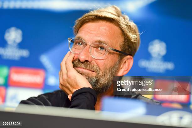 Liverpool's coach Juergen Klopp laughs during a press conference previously to the Champions League's qualifer match between 1899 Hoffenheim and FC...