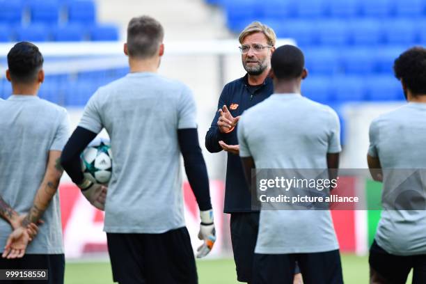 Liverpool's coach Juergen Klopp speaks to his players during the training session in preparation of the Champions League's qualifer match between...