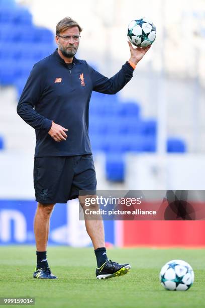 Liverpool's coach Juergen Klopp holds a ball in his hands during the training session in preparation of the Champions League's qualifer match between...