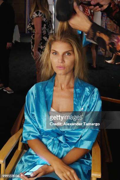 Model prepares backstage for Luli Fama during the Paraiso Fashion Fair at The Paraiso Tent on July 14, 2018 in Miami Beach, Florida.