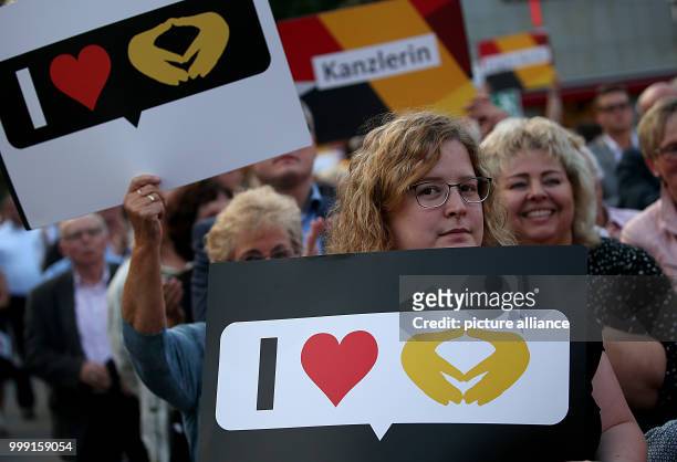 Supporters carrying banners follow the campaign appearance of the Christian Democratic Union of Germany for the federal parliamentary elections 2017...