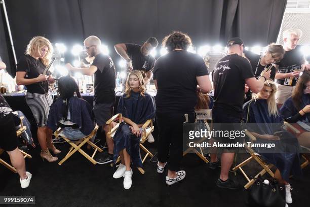 Models prepare backstage for Luli Fama during the Paraiso Fashion Fair at The Paraiso Tent on July 14, 2018 in Miami Beach, Florida.