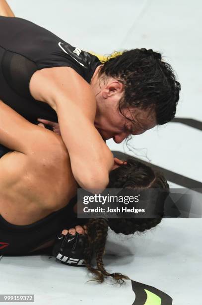 Cat Zingano elbows Marion Reneau in their women's bantamweight fight during the UFC Fight Night event inside CenturyLink Arena on July 14, 2018 in...