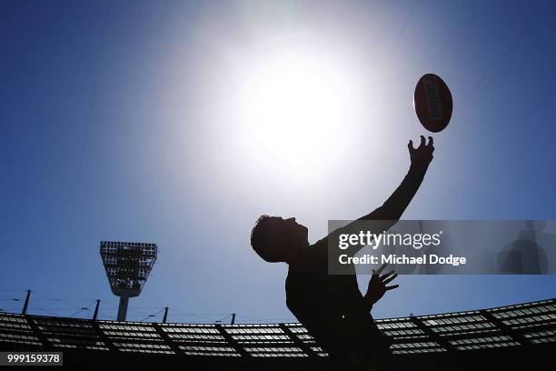Boundary umpire throws the ball in his warm up during the round 17 AFL match between the Collingwood Magpies and the West Coast Eagles at Melbourne...
