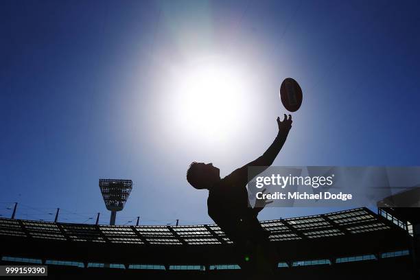 Boundary umpire throws the ball in his warm up during the round 17 AFL match between the Collingwood Magpies and the West Coast Eagles at Melbourne...