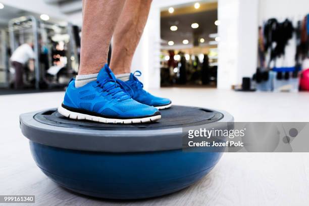 unrecognizable senior man in gym standing on bosu balance ball - jozef polc stock pictures, royalty-free photos & images