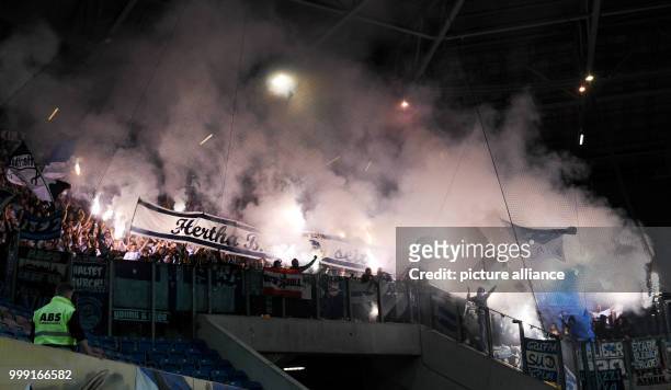 Berlin supporters lighting fireworks during the DFB Cup match pitting Hansa Rostock vs Hertha BSC at the Ostsee Stadium in Rostock, Germany, 14...