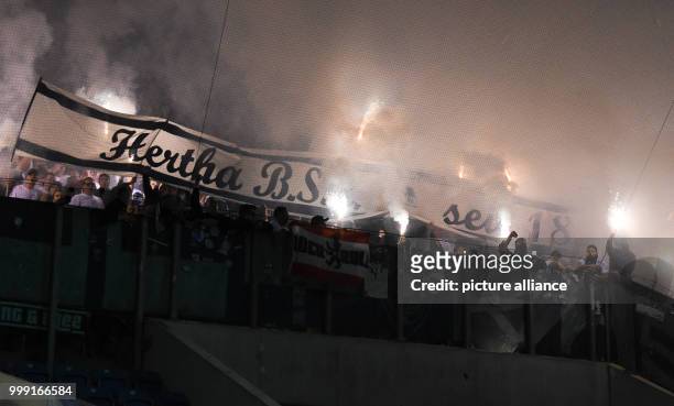 Berlin supporters lighting fireworks during the DFB Cup match pitting Hansa Rostock vs Hertha BSC at the Ostsee Stadium in Rostock, Germany, 14...