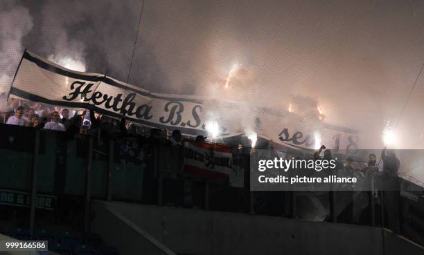 Berlin supporters lighting fireworks during the DFB Cup match pitting Hansa Rostock vs Hertha BSC at the Ostsee Stadium in Rostock, Germany, 14...