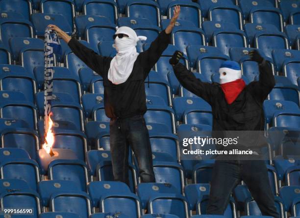 Hooligans burning a Hertha fan's scarf during the DFB Cup match pitting Hansa Rostock vs Hertha BSC at the Ostsee Stadium in Rostock, Germany, 14...