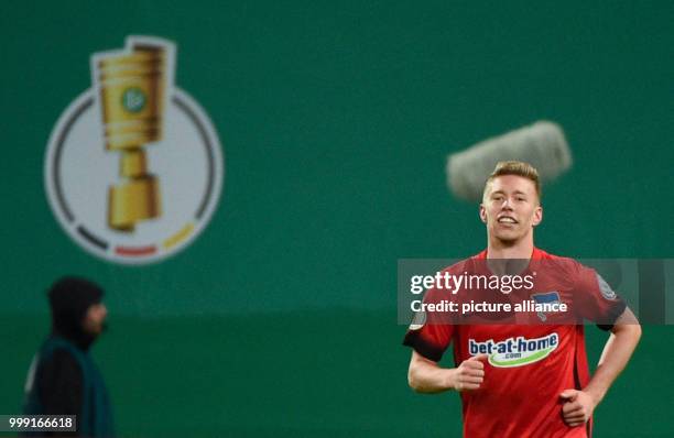 Berlin's Mitchell Weiser celebrates his scoring of the opening goal during the DFB Cup match pitting Hansa Rostock vs Hertha BSC at the Ostsee...