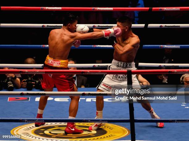 Edivaldo Ortega of Mexico fight with Jhack Tepora of Philippines during their World Featherweight boxing championship title bout in Kuala Lumpur,...