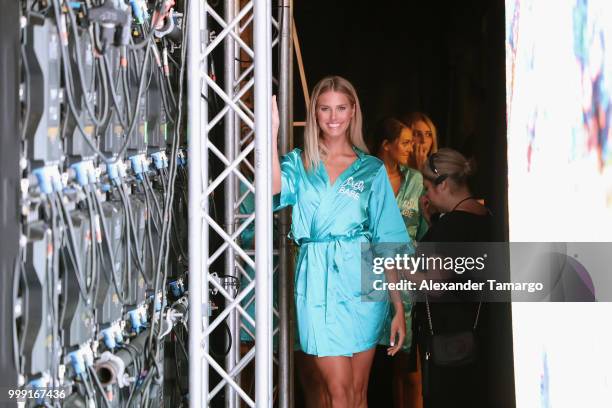 Model prepares backstage for Sinesia Karol during the Paraiso Fashion Fair at The Paraiso Tent on July 14, 2018 in Miami Beach, Florida.