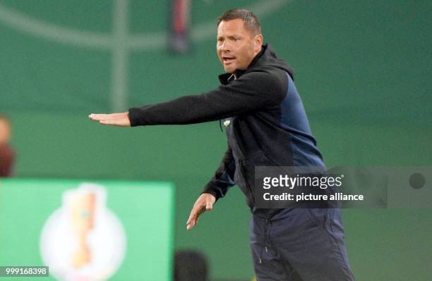 Berlin head coach Pal Dardai gestures from the sidelines during the DFB Cup match pitting Hansa Rostock vs Hertha BSC at the Ostsee Stadium in...