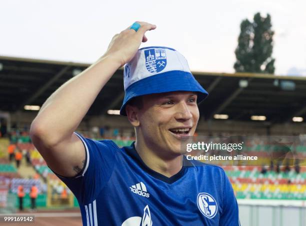 Schalke's two-time scorer Jewgeni Konopljanka wearing a Schalke hat after the final whistle of the DFB Cup match pitting BFC Dynamo vs FC Schalke 04...