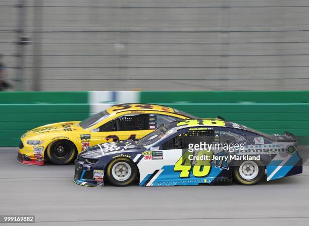 Jimmie Johnson, driver of the Lowe's/Jimmie Johnson Foundation Chevrolet, races Michael McDowell, driver of the Love's Travel Stops/Roller Bites...