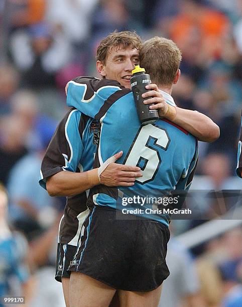 Mat Rogers and team mate Adam Dykes of the Sharks embrace after defeating the Bulldogs in the NRL second semi final match between the Bulldogs and...