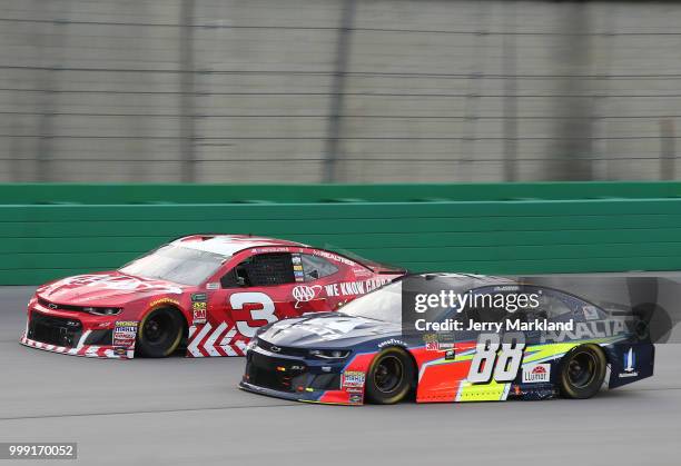 Alex Bowman, driver of the Axalta Chevrolet, races Austin Dillon, driver of the AAA Chevrolet, during the Monster Energy NASCAR Cup Series Quaker...