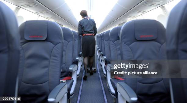 File picture dated 24 February 2012 showing a stewardess walking a board a Boeing 737 in the Air Berlin Hall in Dusseldorf, Germany. Air Berlin has...