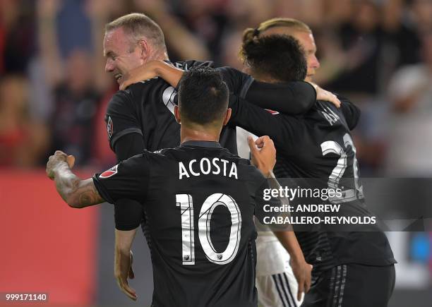 Wayne Rooney of DC United celebrates with teammates after a goal was scored during the DC United vs the Vancouver Whitecaps FC match in Washington DC...