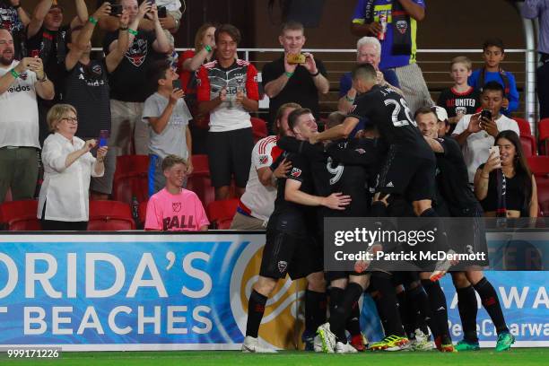 Paul Arriola of D.C. United celebrates with his teammates after scoring a goal in the second half against the Vancouver Whitecaps at Audi Field on...