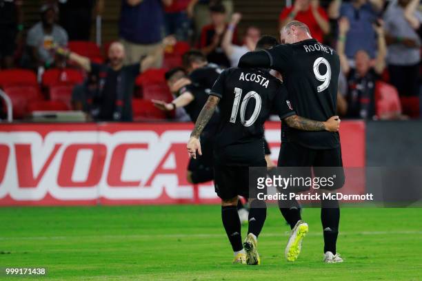 Wayne Rooney and Luciano Acosta of D.C. United celebrate after Paul Arriola , scored a goal in the second half against the Vancouver Whitecaps at...