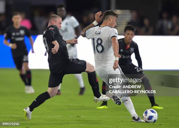 Wayne Rooney of DC United vies for the ball with Jose Aja from the Vancouver Whitecaps FC during their match in Washington DC on July 14, 2018.