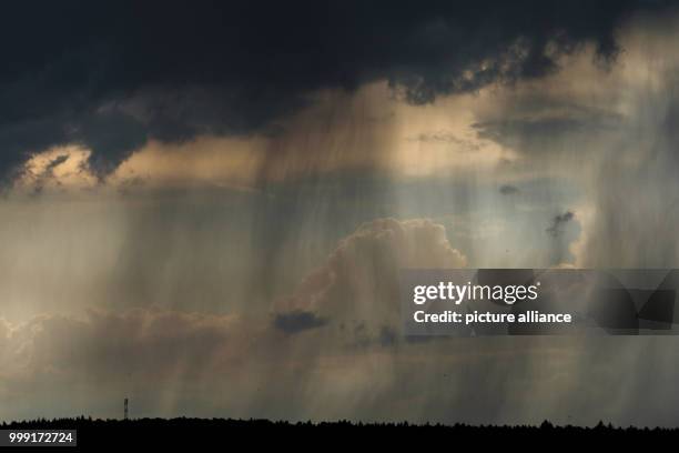 Dark thunder clouds and rain can be seen above Ebing, Germany, 15 August 2017. Photo: Nicolas Armer/dpa