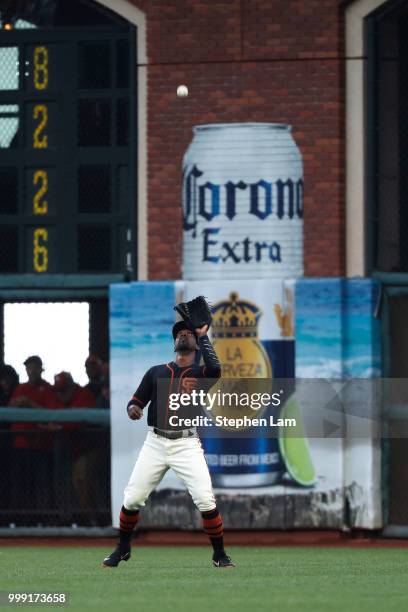 Andrew McCutchen of the San Francisco Giants catches a flyball during the first inning against the Oakland Athletics at AT&T Park on July 14, 2018 in...