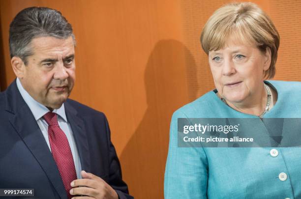 German Chancellor Angela Merkel and Foreign Minister Sigmar Gabriel before the start of a cabinet session in the federal chancellery in Berlin,...